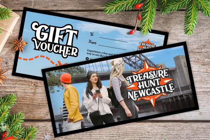 A gift voucher for Treasure Hunt Newcastle on a table covered with Christmas decorations